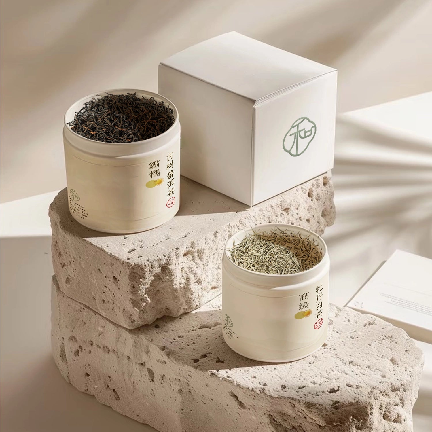 two opened elegant white tea tins with luxury chinese ancient tree puer loose tea leaves and white loose teas leaves showing the teas texture with a simple branded and elegant white box