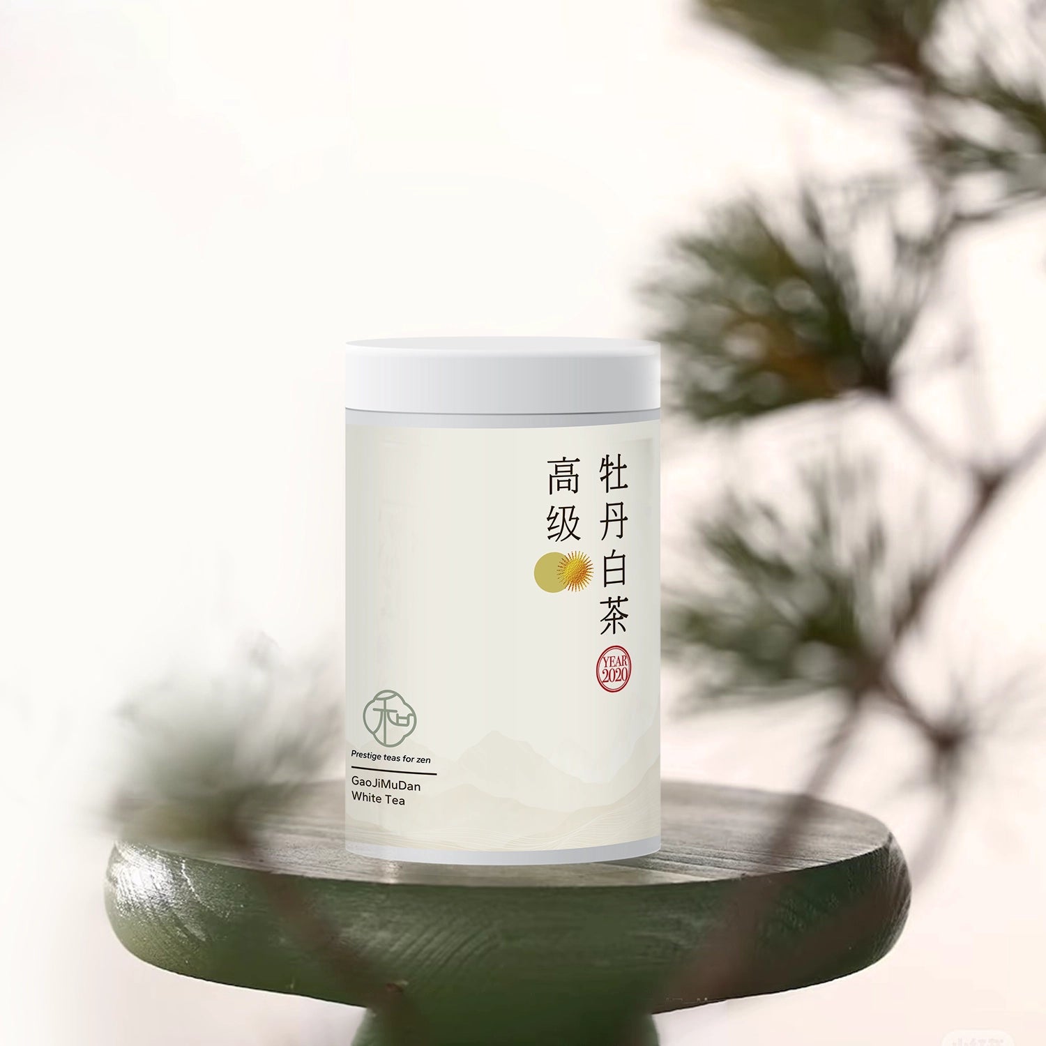 Single tea tin of luxury chinese huangyeshoumei loose white tea packaged in branded elegant white tea tin set against blurred greenery