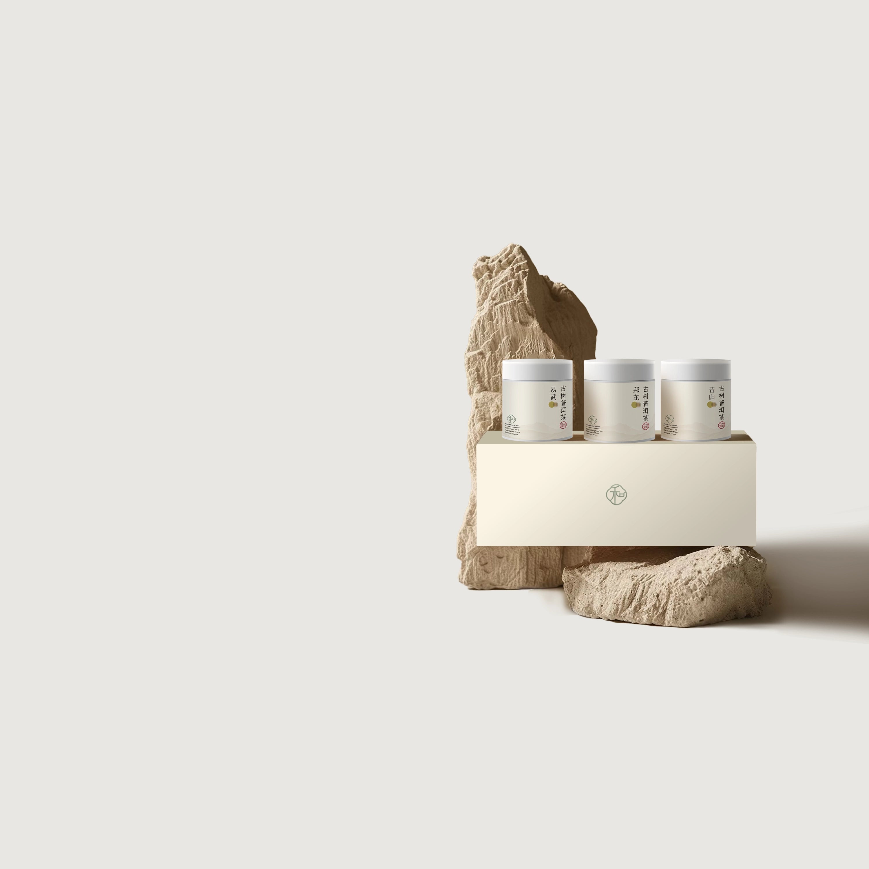 a set of miniature tea gift set with three premium Chinese ancient tree puer loose leaf teas packaged in white tea tins in branded elegant white packaging